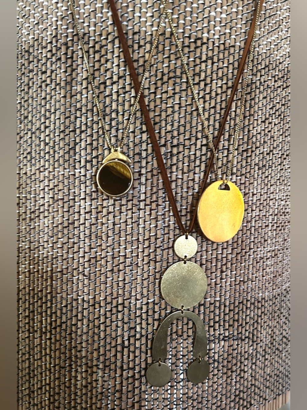 Mixed stack of three gold tone brass pendant necklaces.